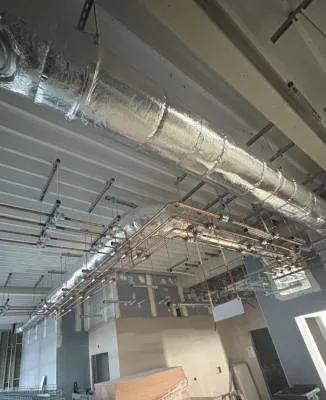 Insulated ducting and copper pipework installed in a commercial building