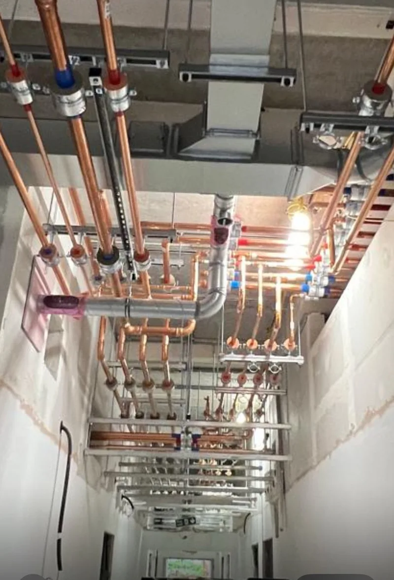 Copper pipework installed in a ceiling for commercial plumbing in Newark